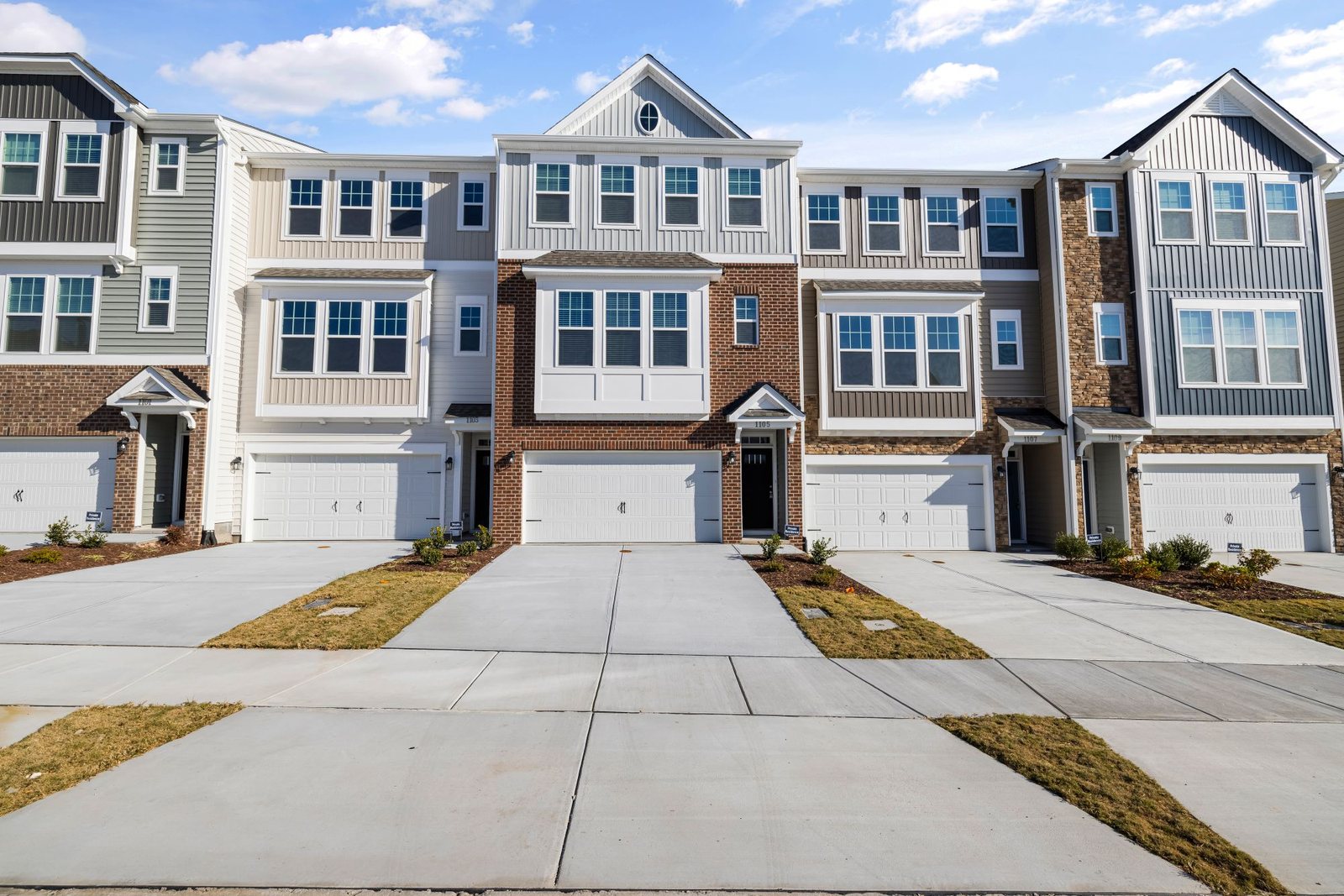 Row of new two-story townhomes with front garages