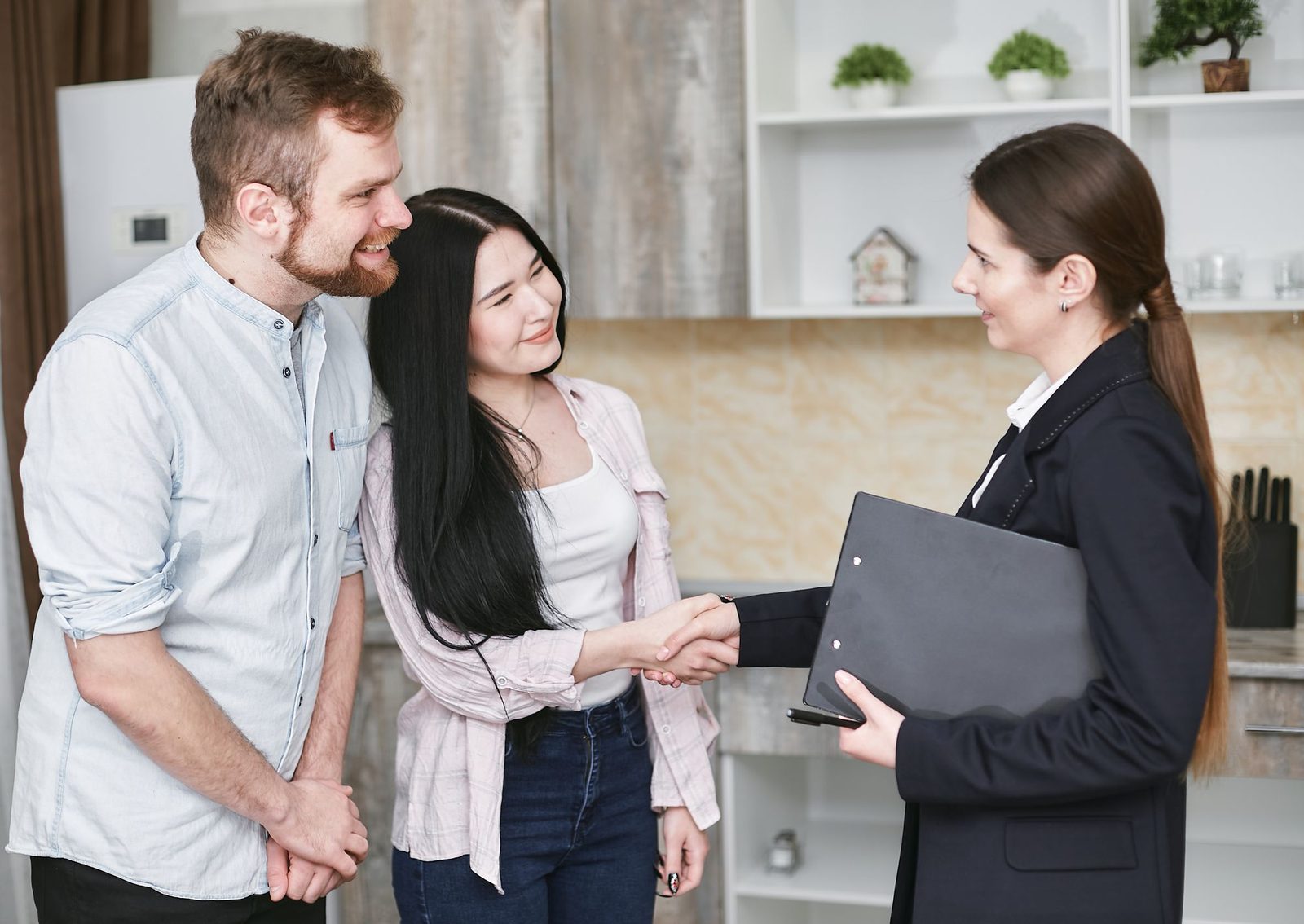 Couple meeting with a mortgage advisor at a desk to review loan options