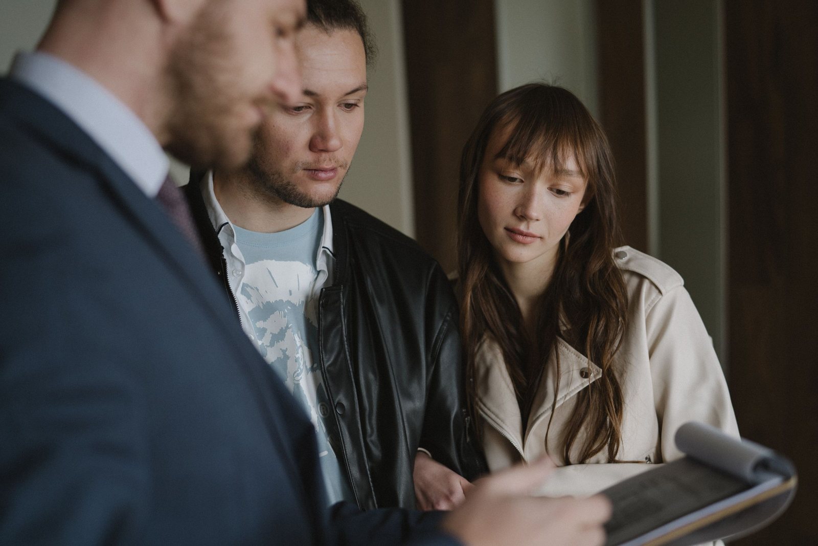 Young couple reviewing loan details on a tablet with an advisor
